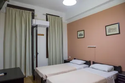 a room with two beds in a room at Tempi Hotel in Athens