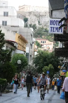 a group of people walking down a city street at Tempi Hotel in Athens