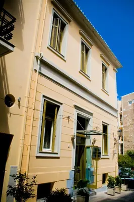 a large white building with windows at Acropolis House Hotel Classic in Athens