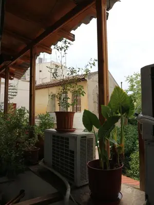 a balcony with a heater and potted plants on it at Acropolis House Hotel Classic in Athens