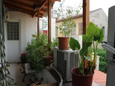 a balcony with potted plants sitting on a heater at Acropolis House Hotel Classic in Athens