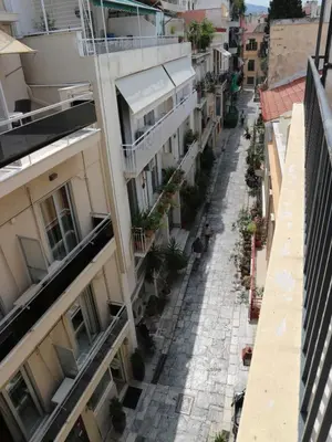 an empty street in a city with buildings at Acropolis House Hotel Classic in Athens