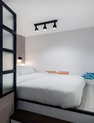 a bedroom with a white bed and a mirror at The Athenians Modern Apartments in Athens