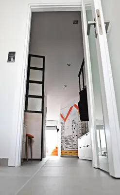 an open door in a room with a ladder at The Athenians Modern Apartments in Athens