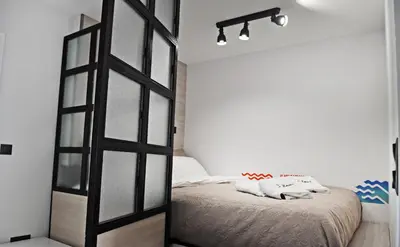 a bedroom with a bed with a large glass door at The Athenians Modern Apartments in Athens