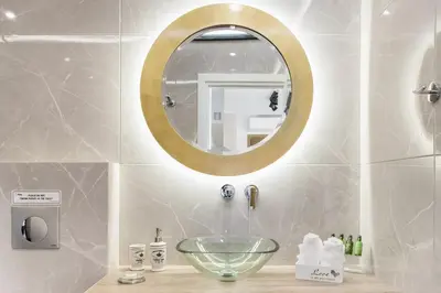 a bathroom with a bowl sink and a mirror at The Athenians Modern Apartments in Athens