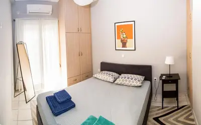 a bedroom with a bed with two pillows on it at Gazi Area close to Subway in Athens