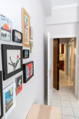 a hallway with a bunch of pictures on a wall at Gazi Area close to Subway in Athens