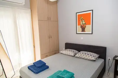 a bedroom with a bed with two pillows on it at Gazi Area close to Subway in Athens