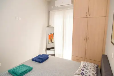 a bedroom with a bed and a mirror in it at Gazi Area close to Subway in Athens