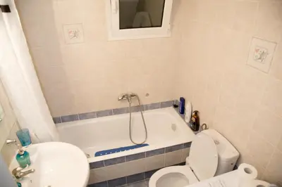 a bathroom with a tub and a toilet and a sink at Gazi Area close to Subway in Athens