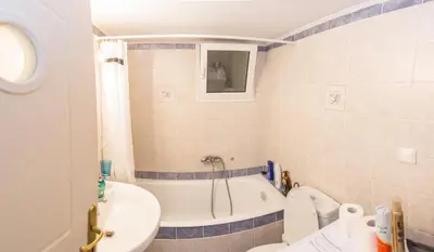 a bathroom with a tub and a toilet and a sink at Gazi Area close to Subway in Athens