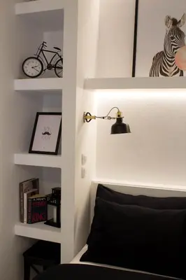 a room with a bed and a lamp and shelves at Super Stylish Apartments in Syntagma Square! in Athens