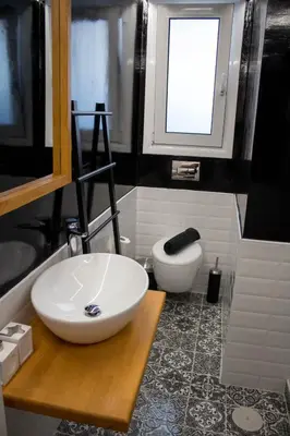 a bathroom with a white sink and a window at Super Stylish Apartments in Syntagma Square! in Athens