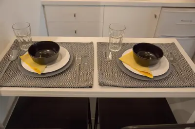 a table with two bowls and napkins and glasses at Super Stylish Apartments in Syntagma Square! in Athens