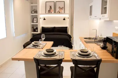 a kitchen and living room with a table and chairs at Super Stylish Apartments in Syntagma Square! in Athens