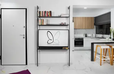 a kitchen with a refrigerator with a logo on it at Elysium Boutique Apartments in Athens