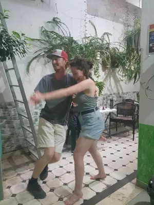 a man and a woman dancing in a room at Pagration Youth Hostel in Athens