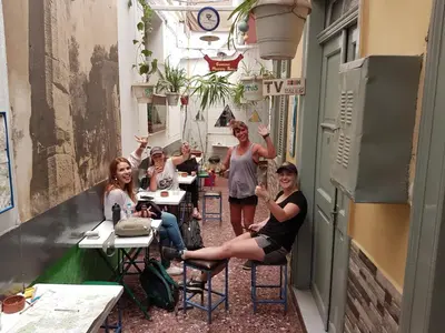 a group of people sitting at tables in a restaurant at Pagration Youth Hostel in Athens