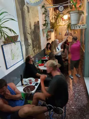 a group of people sitting at tables in a restaurant at Pagration Youth Hostel in Athens
