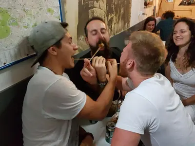 a group of people brushing a mans teeth at Pagration Youth Hostel in Athens
