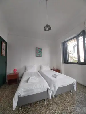 a bedroom with two beds with white sheets at Central 2-Bedroom Apartment with Rooftop Access! EP9G in Athens