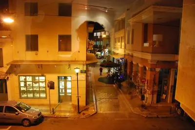 a car parked on a city street at night at Central 2-Bedroom Apartment with Rooftop Access! EP9G in Athens