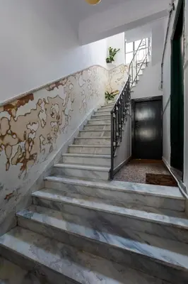 a staircase in a building with a metal door at Central 2-Bedroom Apartment with Rooftop Access! EP9G in Athens