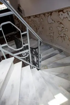 a metal staircase with a chair on top of it at Central 2-Bedroom Apartment with Rooftop Access! EP9G in Athens