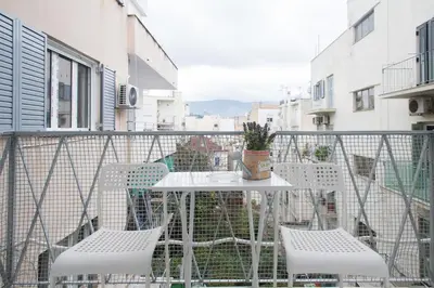a balcony with a white table and chairs at Acropolis Heart in Athens