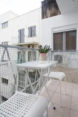 a white table and chairs on a balcony at Acropolis Heart in Athens