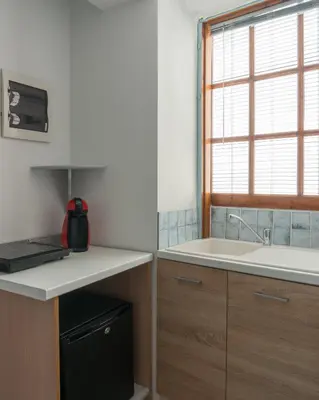 a kitchen with a counter and a sink and a window at The Little Prince in Plaka in Athens