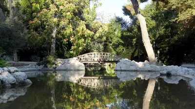 a bridge over a pond in a park at The Little Prince in Plaka in Athens