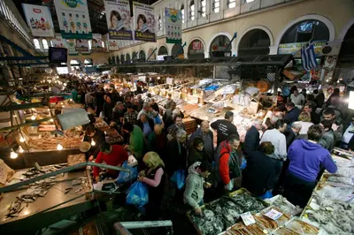 a crowd of people standing in a market at The Little Prince in Plaka in Athens
