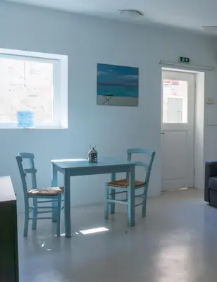 a blue table and chairs in a living room at The Little Prince in Plaka in Athens