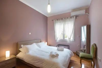 a bedroom with a bed with two towels on it at Keramikos Cozy Apartment by YHA in Athens