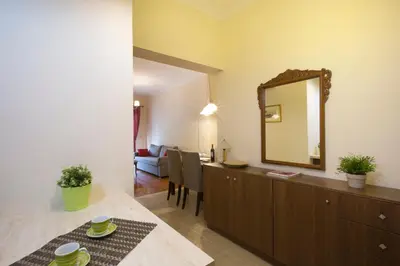 a living room with a mirror on a dresser at Keramikos Cozy Apartment by YHA in Athens