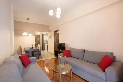 a living room with a couch and a table at Keramikos Cozy Apartment by YHA in Athens