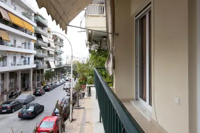 a balcony of a building with cars parked on a street at Keramikos Cozy Apartment by YHA in Athens