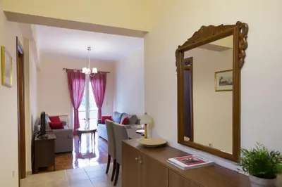 a living room with a mirror and a desk at Keramikos Cozy Apartment by YHA in Athens