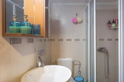 a bathroom with a sink and a shower at Keramikos Cozy Apartment by YHA in Athens