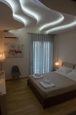 a bedroom with a bed with two towels on it at Alke Homme in Athens