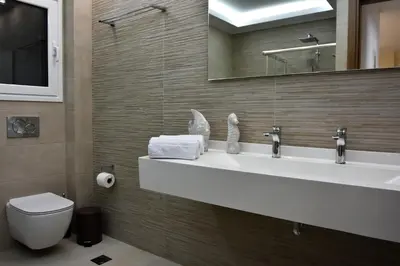 a bathroom with a sink and a toilet and a mirror at Alke Homme in Athens
