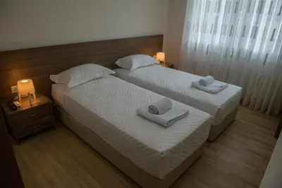 two beds in a bedroom with towels on them at Alke Homme in Athens