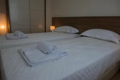 a white bed with towels and pillows on it at Alke Homme in Athens