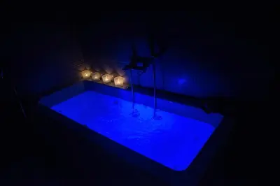 a blue tub with lights in a dark room at Alke Homme in Athens
