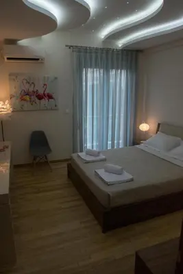 a bedroom with a bed with two towels on it at Alke Homme in Athens