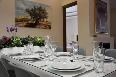 a table with white plates and glasses on it at Alke Homme in Athens