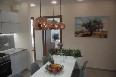 a kitchen with a table with a bowl of fruit on it at Alke Homme in Athens