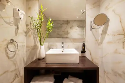 a bathroom with a white sink and a mirror at Best Western Plus Embassy Hotel in Athens
